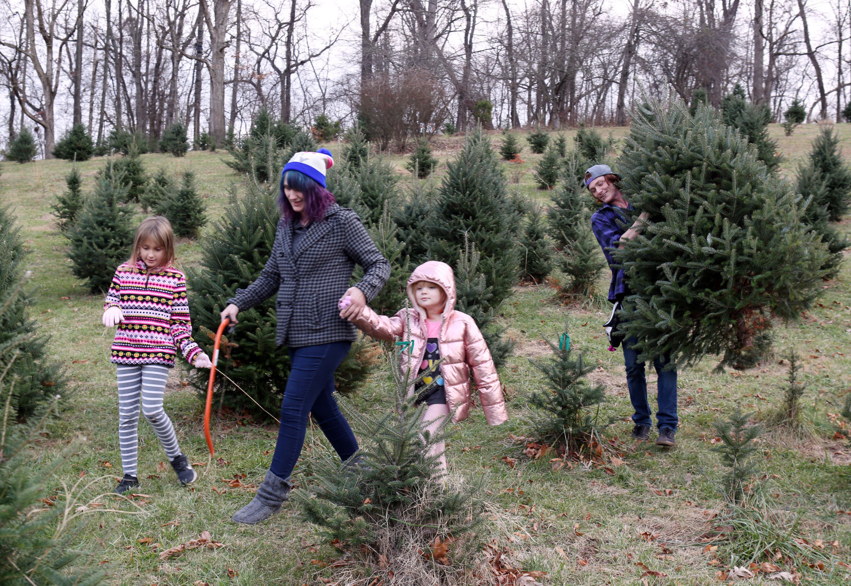 Keri and Daniel Hull with their daughters at Hamill Christmas Tree Farm in Roanoke